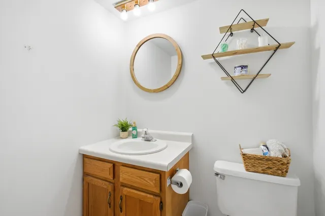 a bathroom with a sink mirror and vanity