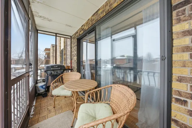 a view of a dining room with furniture large windows and wooden floor