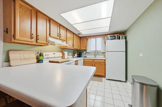 a kitchen with stainless steel appliances a refrigerator sink and cabinets
