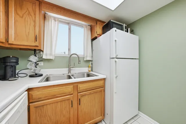 a kitchen with a sink a refrigerator a washer and dryer