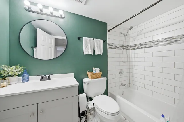 a bathroom with a sink mirror toilet and bathtub