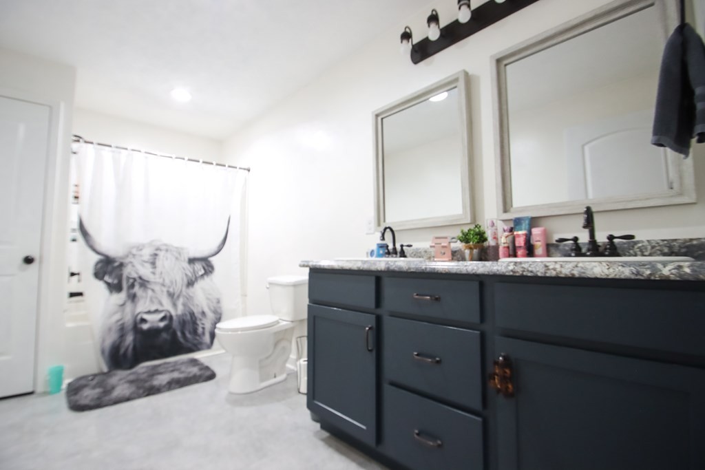 131 Collingwood Road Walling, TN 38587 - Photo 14 of 26 a bathroom with a double vanity sink and a mirror