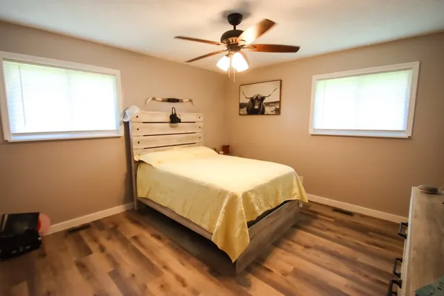 a bedroom with a bed and a chandelier