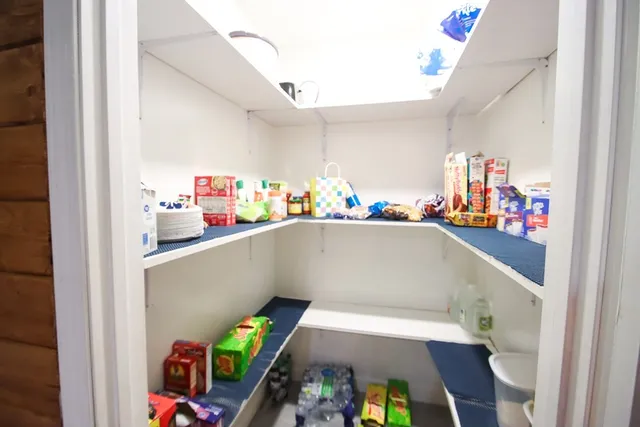 a utility room with dryer washer and a view of living room