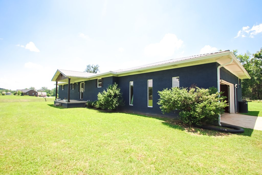 131 Collingwood Road Walling, TN 38587 - Photo 2 of 26 a front view of house with yard and trees in the background