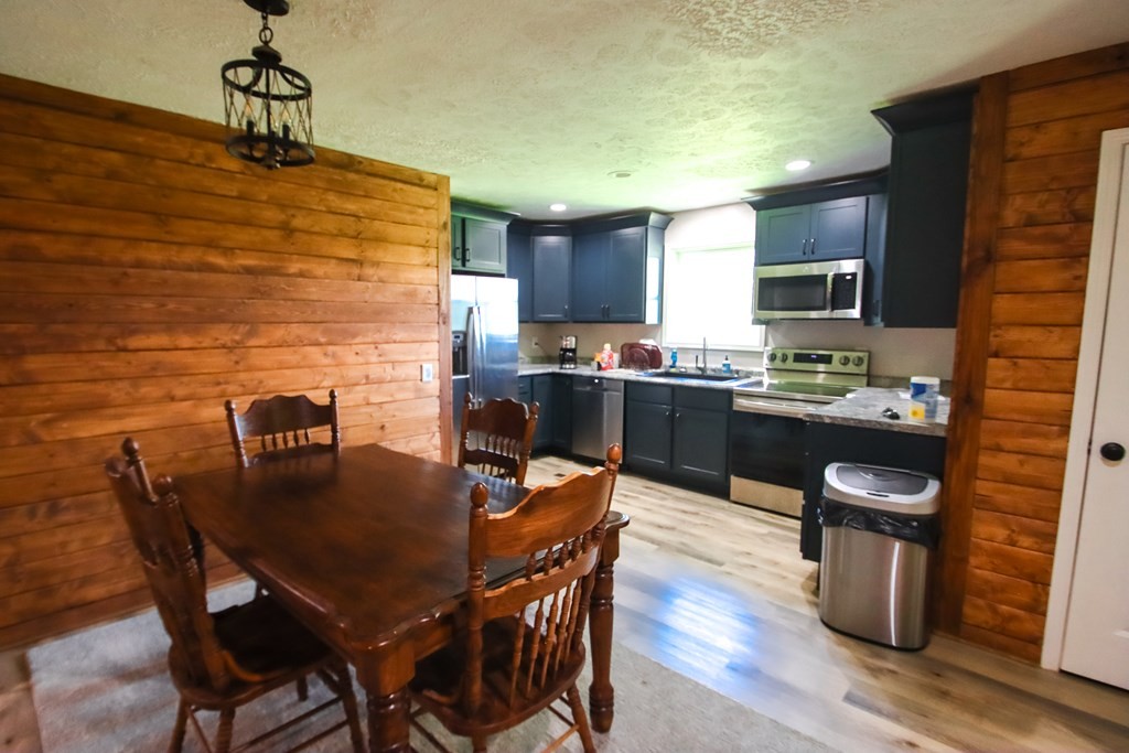 131 Collingwood Road Walling, TN 38587 - Photo 7 of 26 a kitchen with granite countertop a sink dining table and chairs