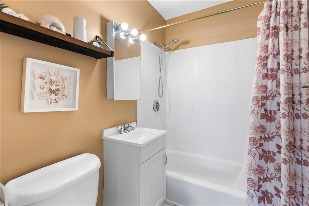 115 Grove Street, Unit 11 Boston, MA 02132 - Photo 16 of 29 a bathroom with a toilet and a bathtub