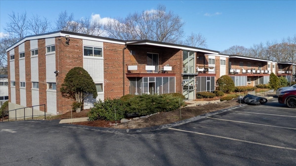 115 Grove Street, Unit 11 Boston, MA 02132 - Photo 22 of 29 a front view of a house with parking area