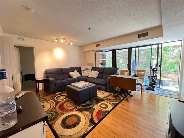 a living room with furniture and a wooden floor