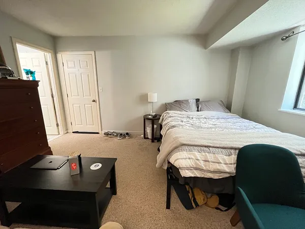 a bedroom with a bed and a window