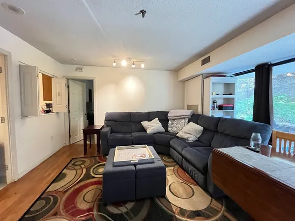 a living room with furniture and a wooden floor