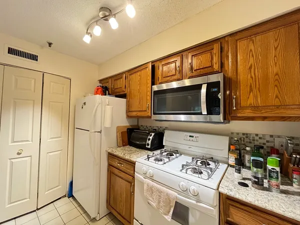 a kitchen with stainless steel appliances a stove a microwave and cabinets