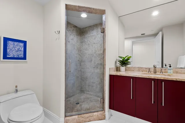 a spacious bedroom with a bed and glass window