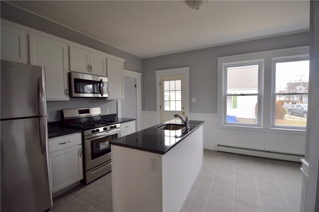 476 Power Road Pawtucket, RI 02860 - Photo 5 of 11 New kitchen with granite countertops, island and new stainless steel appliances