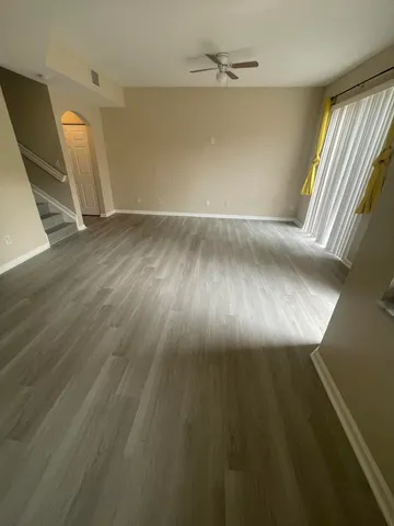 wooden floor in an empty room with a window