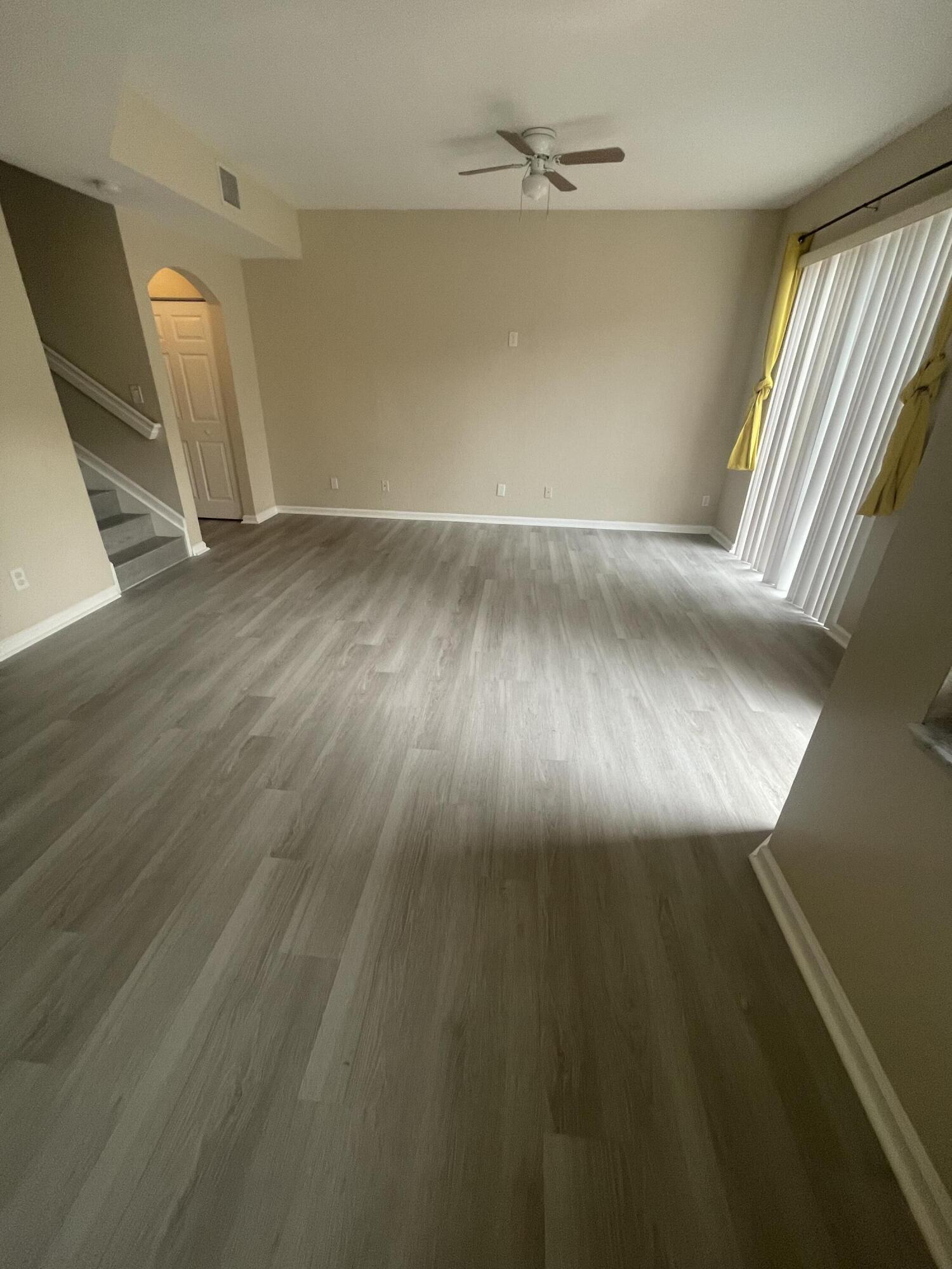 wooden floor in an empty room with a window