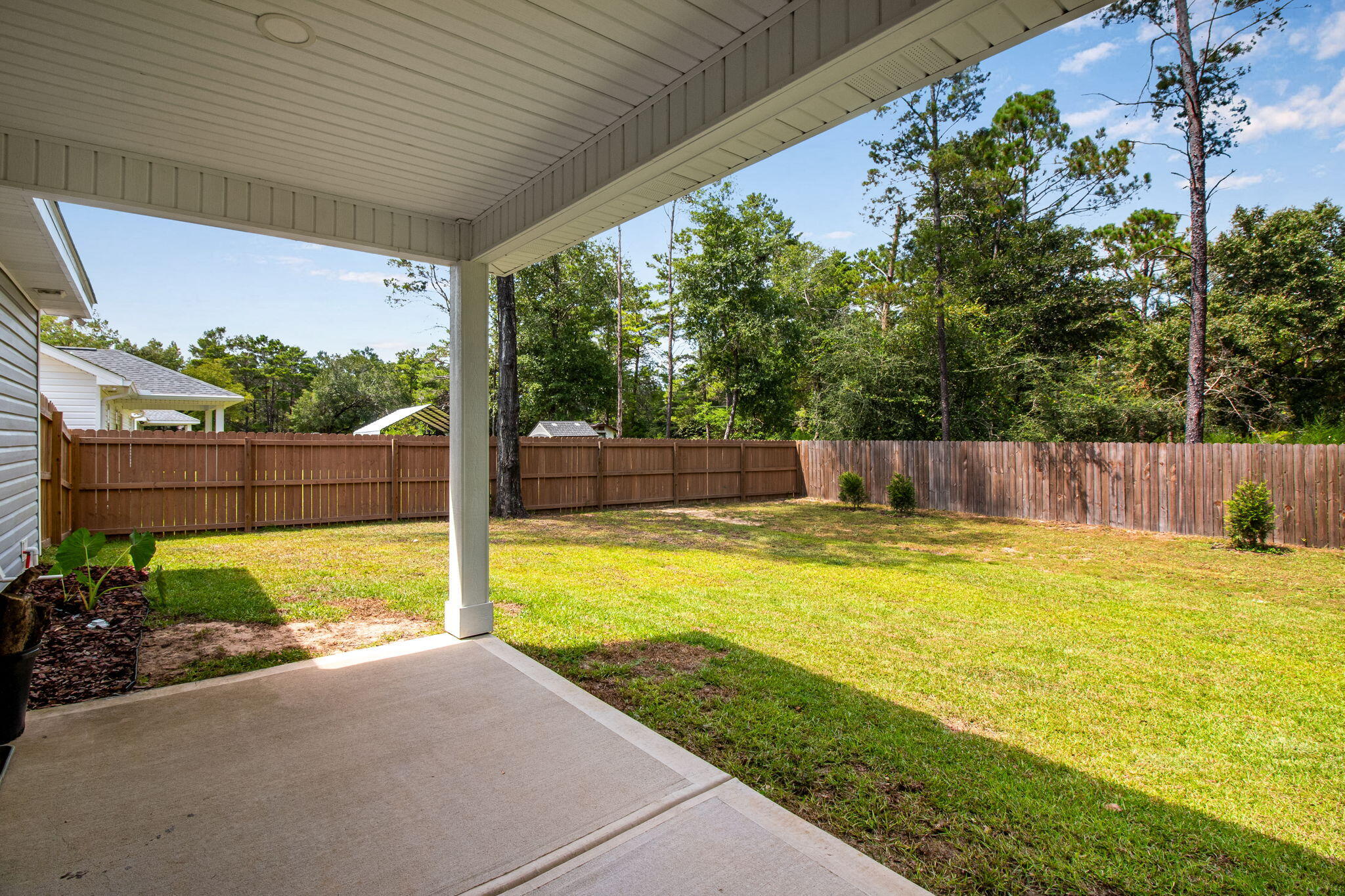 43 Crocus Avenue DeFuniak Springs, FL 32433 - Photo 18 of 20 a view of a backyard with plants and a garden