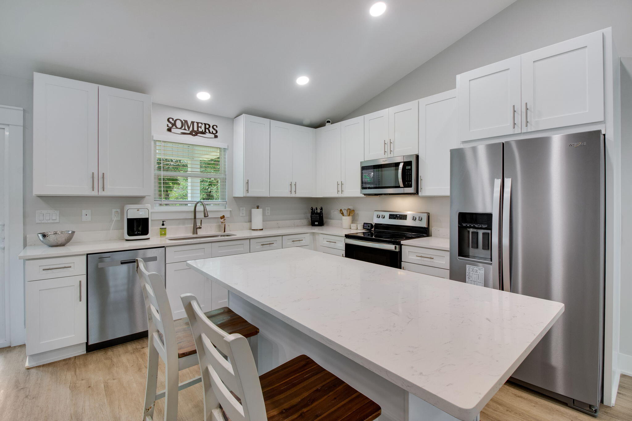 43 Crocus Avenue DeFuniak Springs, FL 32433 - Photo 7 of 20 a kitchen with a refrigerator a stove a sink and white cabinets