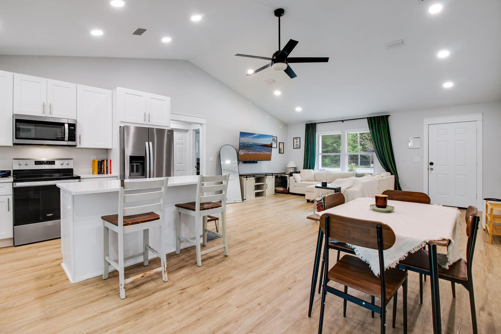 43 Crocus Avenue DeFuniak Springs, FL 32433 - Photo 9 of 20 a kitchen with stainless steel appliances kitchen island granite countertop a dining table chairs refrigerator and sink