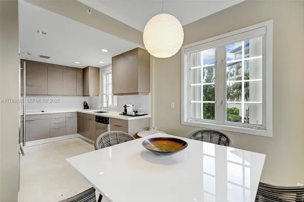 a kitchen with a sink a stove a refrigerator and white cabinets with wooden floor