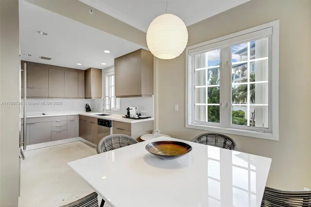 a kitchen with a sink a stove a refrigerator and white cabinets with wooden floor