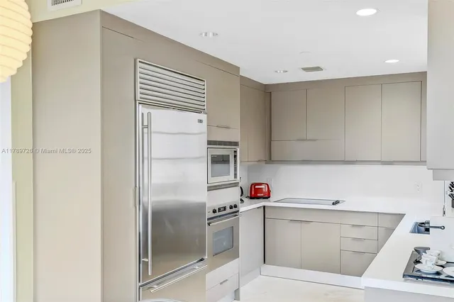 a kitchen with a sink cabinets and stainless steel appliances
