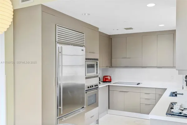 a kitchen with a sink cabinets and stainless steel appliances