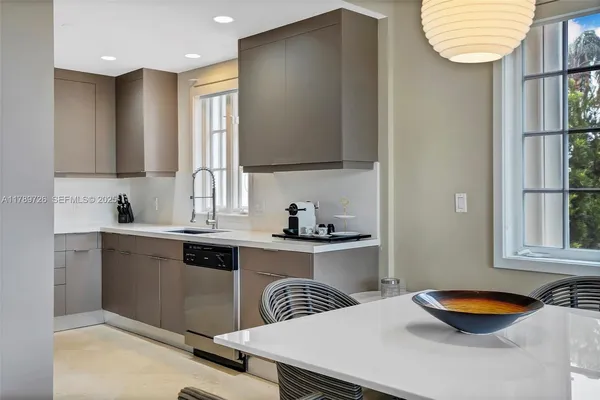 a kitchen with stainless steel appliances a sink and a wooden cabinets