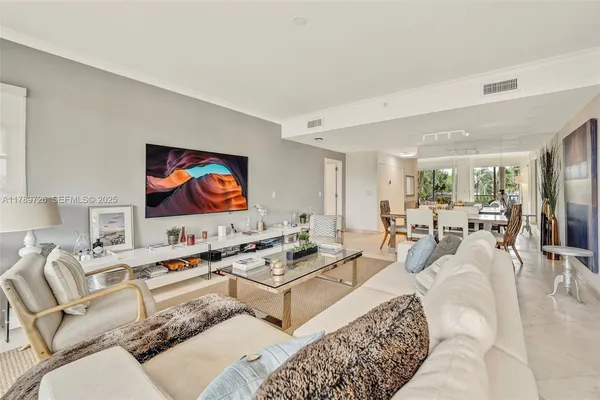 a living room with furniture kitchen view and a large window