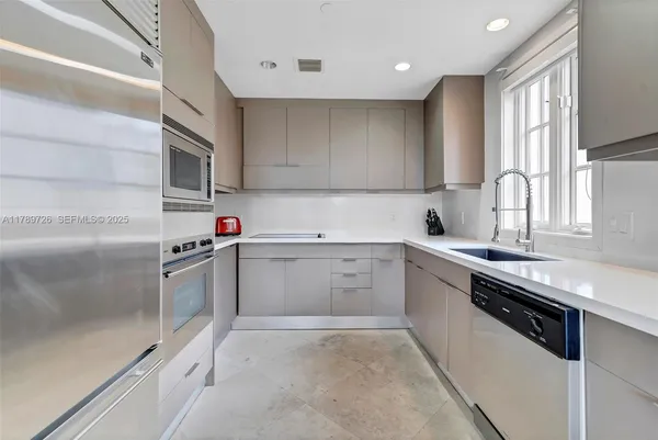 a kitchen with a sink cabinets and stainless steel appliances