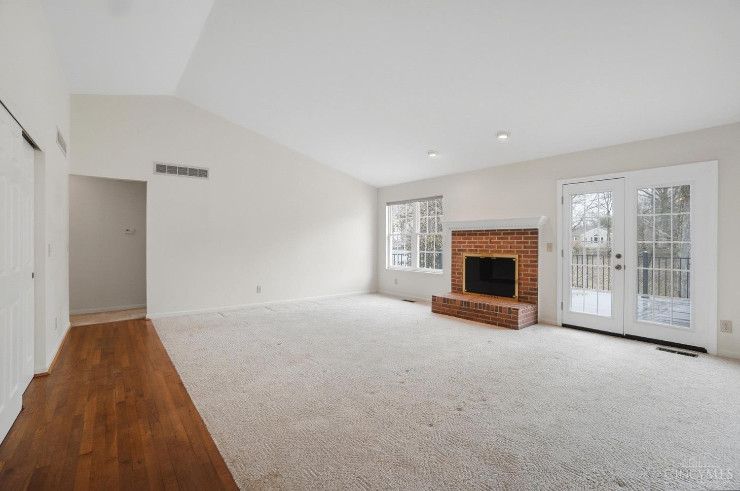 1090 West Galbraith Road Cincinnati, OH 45231 - Photo 5 of 37 The great room has vaulted ceiling, wood burning fireplace and access to the newer composite deck.