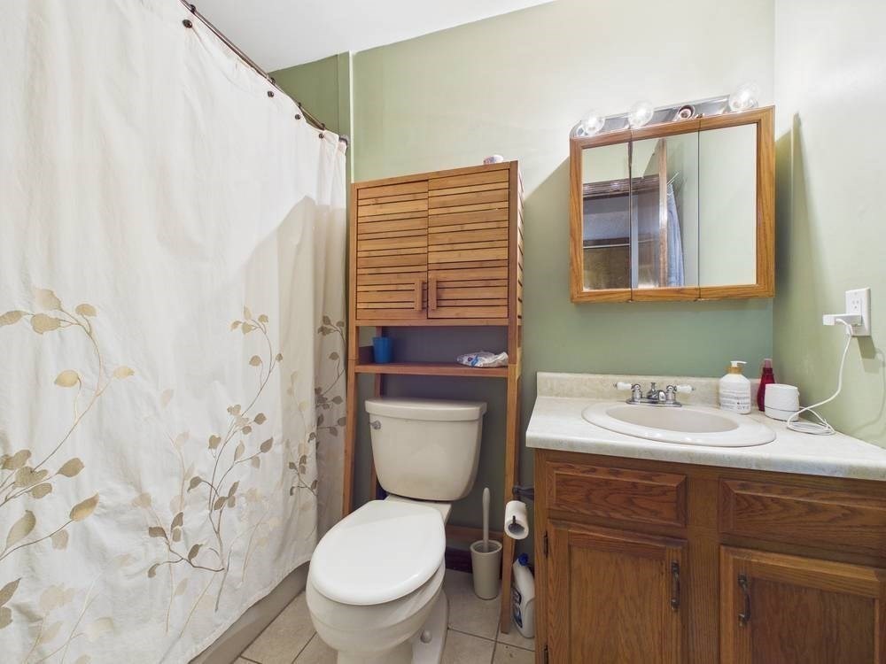 1940 Phillips Road, Unit 17 New Bedford, MA 02745 - Photo 12 of 18 a bathroom with a sink a toilet and a mirror