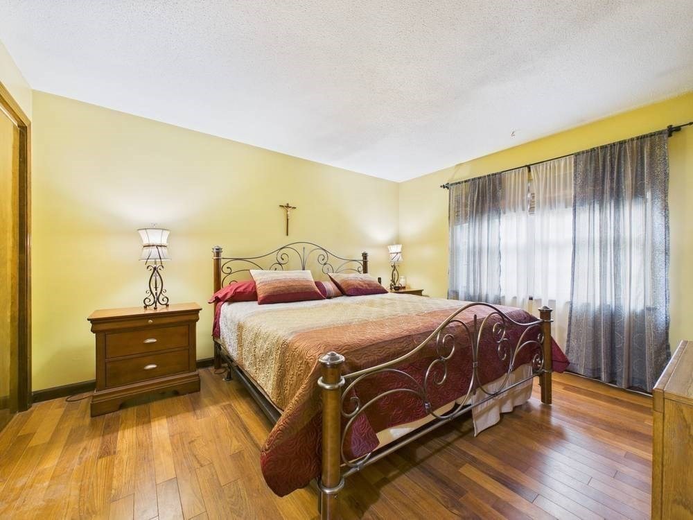 1940 Phillips Road, Unit 17 New Bedford, MA 02745 - Photo 14 of 18 a spacious bedroom with a bed and wooden floor