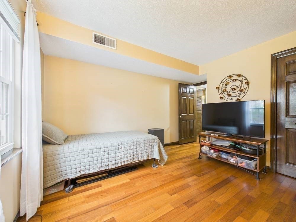 1940 Phillips Road, Unit 17 New Bedford, MA 02745 - Photo 16 of 18 a bedroom with furniture and a flat screen tv