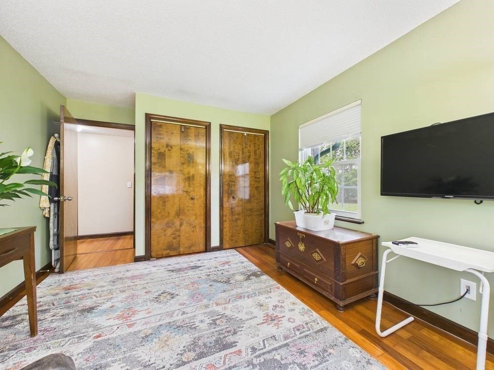 1940 Phillips Road, Unit 17 New Bedford, MA 02745 - Photo 17 of 18 a bedroom with furniture and a flat screen tv