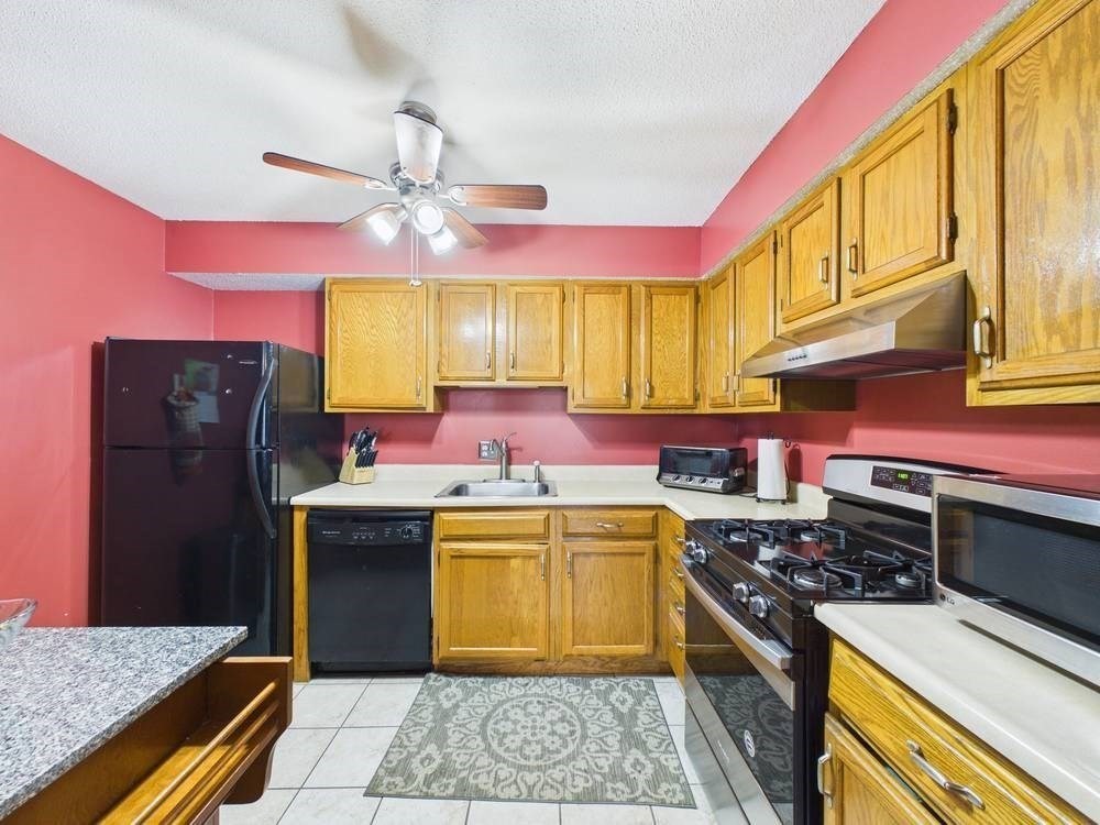 1940 Phillips Road, Unit 17 New Bedford, MA 02745 - Photo 9 of 18 a kitchen with a stove a sink dishwasher and a refrigerator