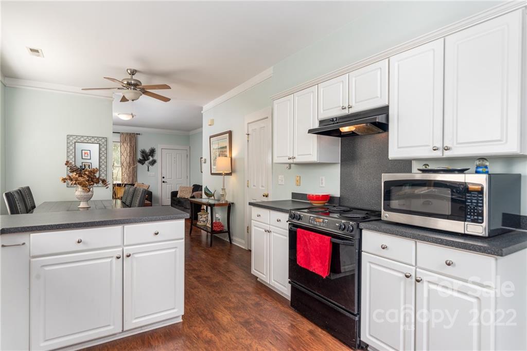 8110 Strandhill Road Huntersville, NC 28078 - Photo 11 of 23 a kitchen with white cabinets and appliances