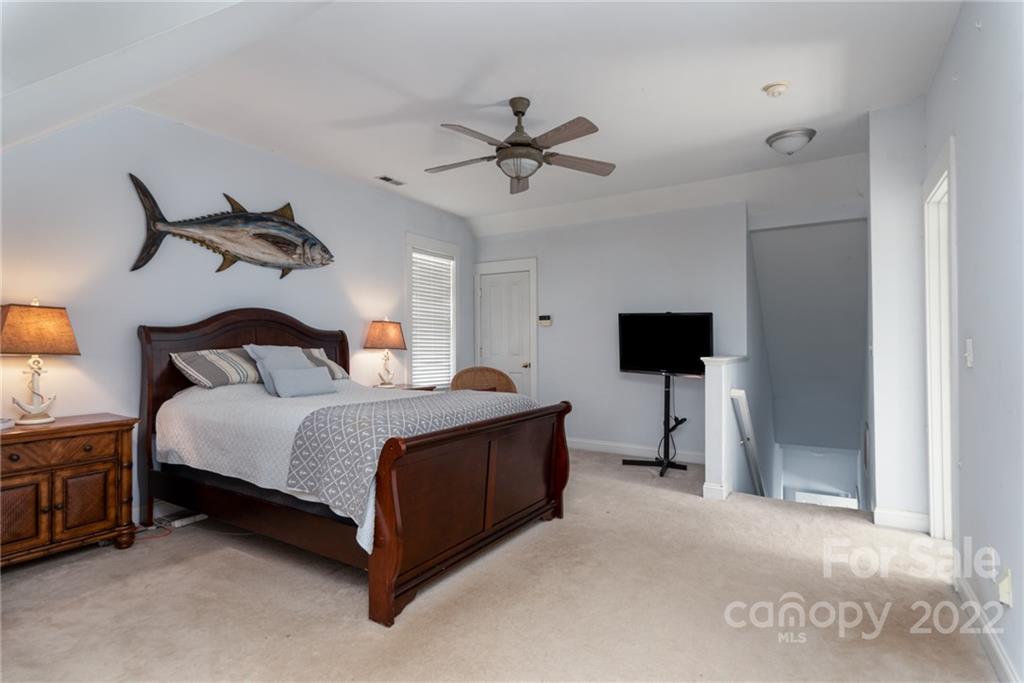 8110 Strandhill Road Huntersville, NC 28078 - Photo 16 of 23 a bedroom with a bed and a chandelier