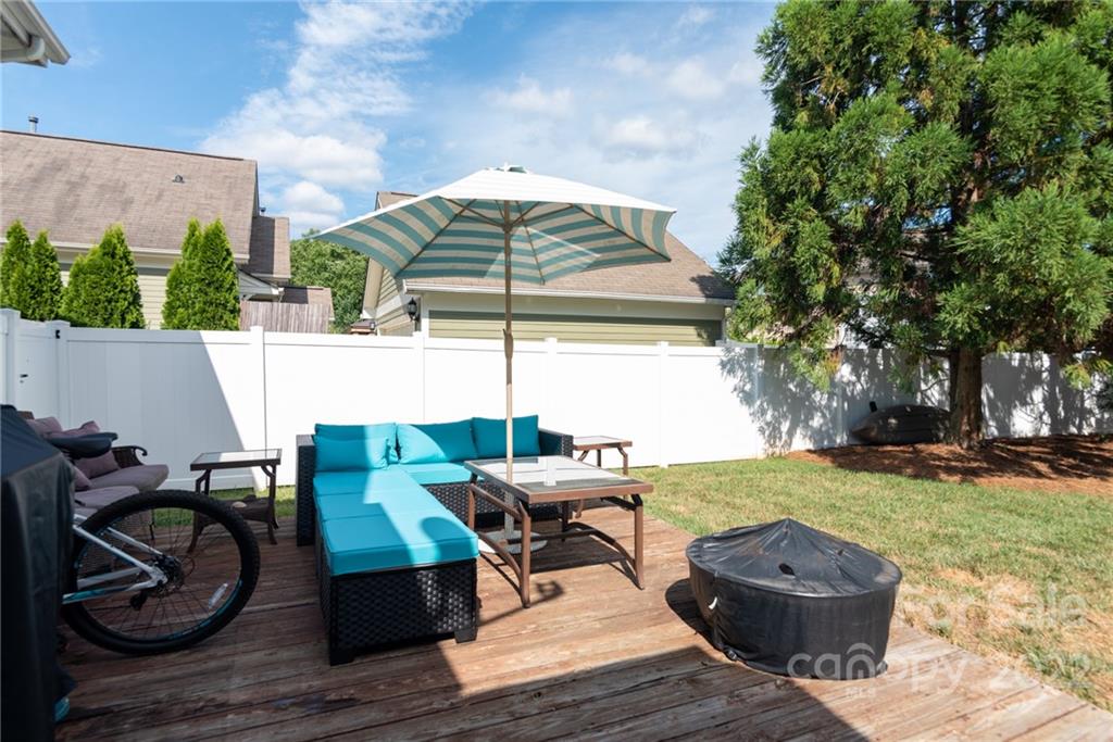 8110 Strandhill Road Huntersville, NC 28078 - Photo 19 of 23 a view of a patio with table and chairs a barbeque with wooden floor