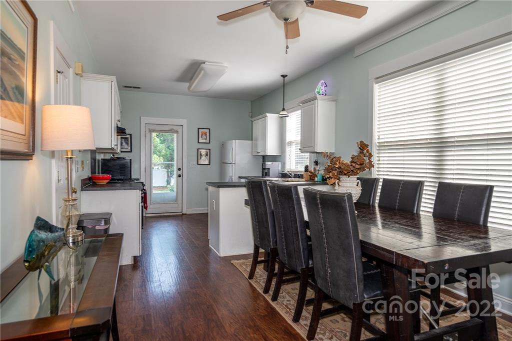 8110 Strandhill Road Huntersville, NC 28078 - Photo 9 of 23 a view of a dining room with furniture and wooden floor