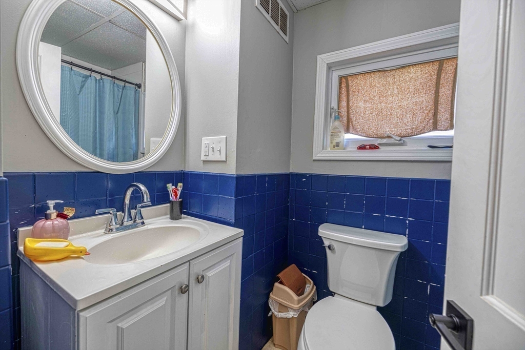 1273-1279 South Main Street Fall River, MA 02724 - Photo 11 of 33 a bathroom with a toilet a sink and a mirror