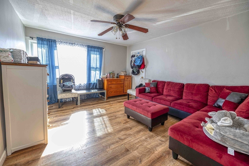 1273-1279 South Main Street Fall River, MA 02724 - Photo 13 of 33 a living room with furniture and a wooden floor