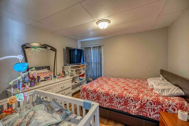 a bedroom with furniture and a wooden floor