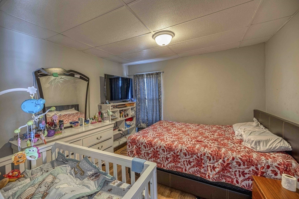 1273-1279 South Main Street Fall River, MA 02724 - Photo 15 of 33 a bedroom with furniture and a wooden floor