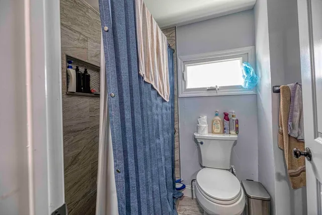 a white toilet sitting next to a bathroom sink