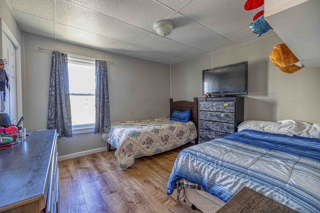 1273-1279 South Main Street Fall River, MA 02724 - Photo 19 of 33 a bedroom with two beds and a flat screen tv