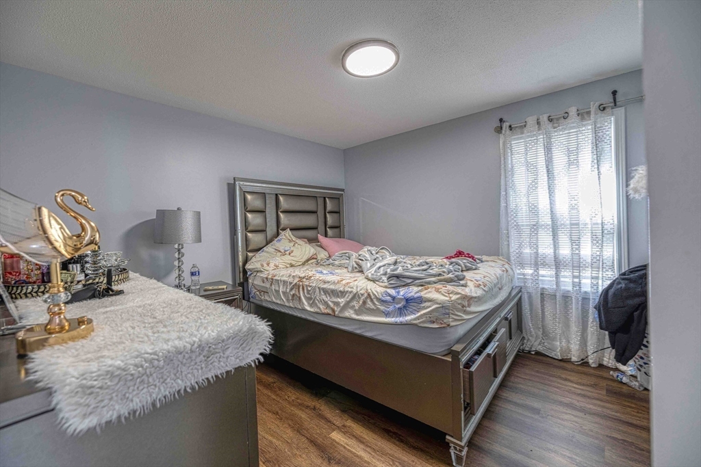 1273-1279 South Main Street Fall River, MA 02724 - Photo 21 of 33 a bed sitting in a bedroom next to a window