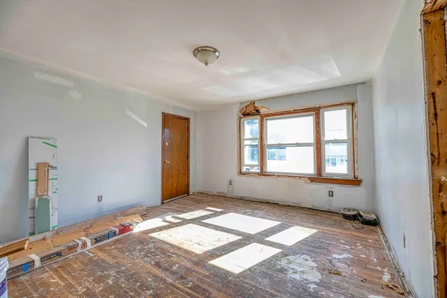 a view of a kitchen with furniture and a refrigerator