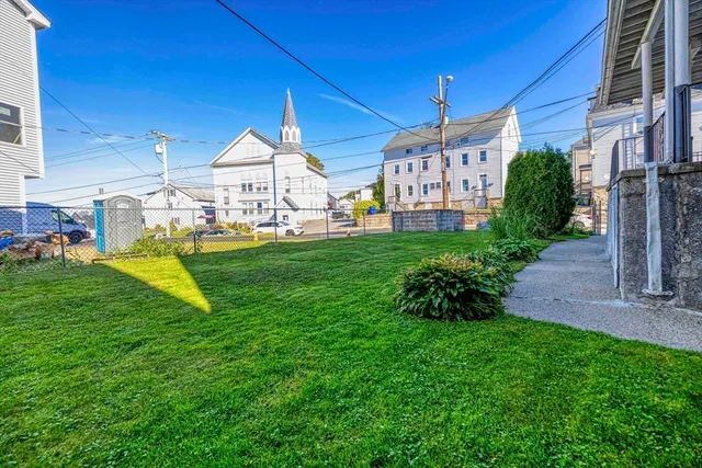 a view of a house with a yard and porch