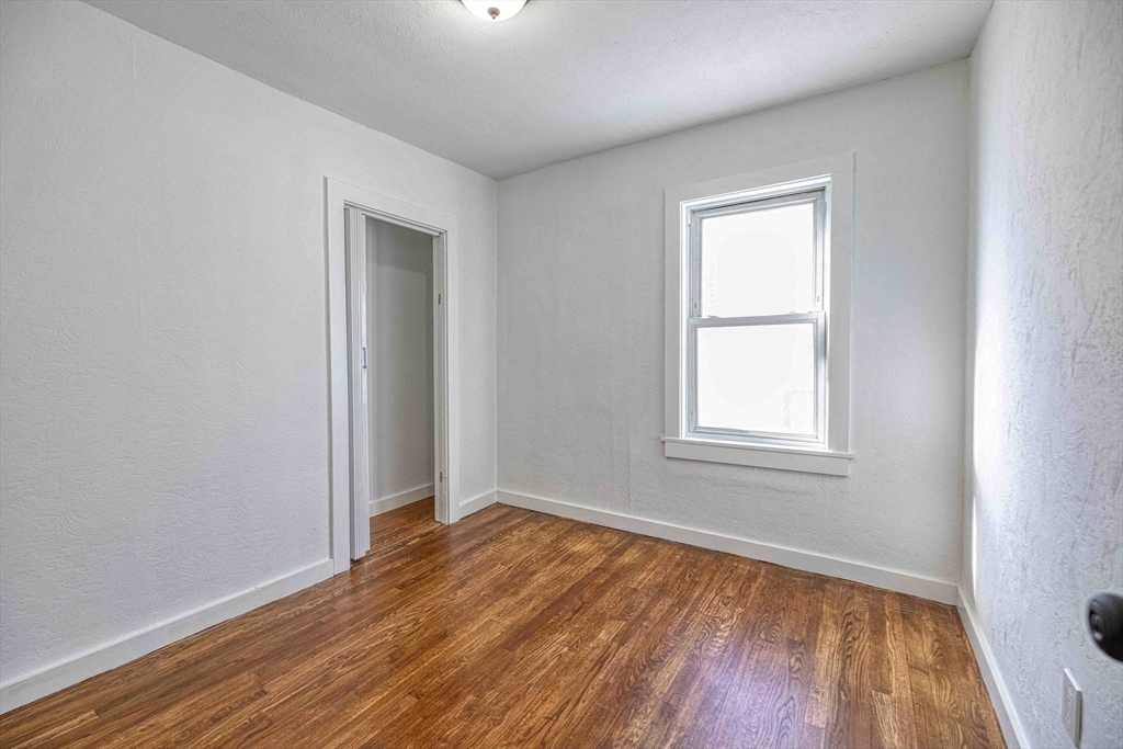 1273-1279 South Main Street Fall River, MA 02724 - Photo 8 of 33 an empty room with wooden floor and windows